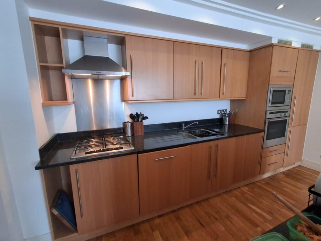 Beech kitchen units with black granite worktop before refurbishment