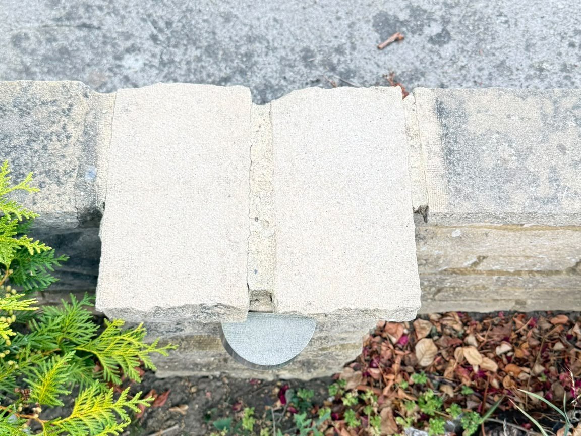 The same coping stones laser cleaned back to their original pale colour, untouched stones either side