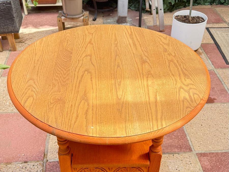 The same oak side table laser cleaned back to bare pale oak with the grain showing and the stain gone