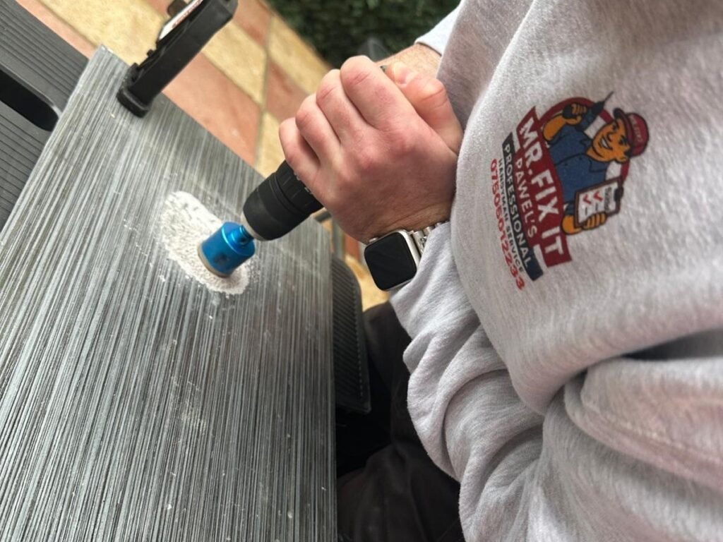 Pawel from Mr Fix It drilling a clean hole through a slate tile with a diamond core bit
