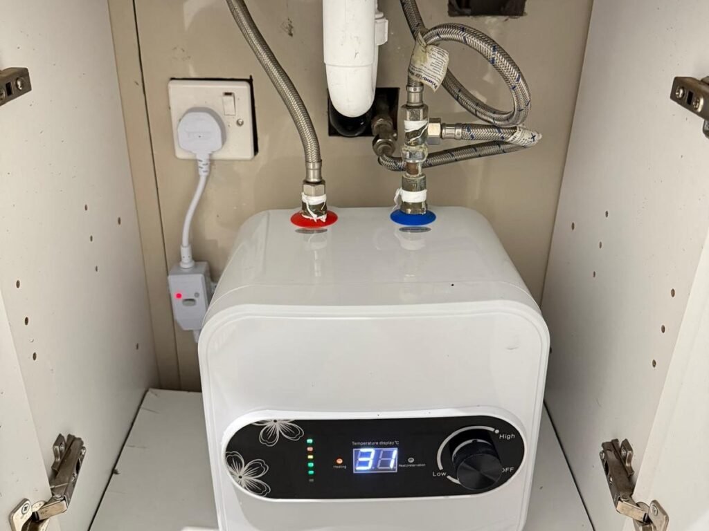 Compact electric water heater plumbed in and wired under a kitchen sink